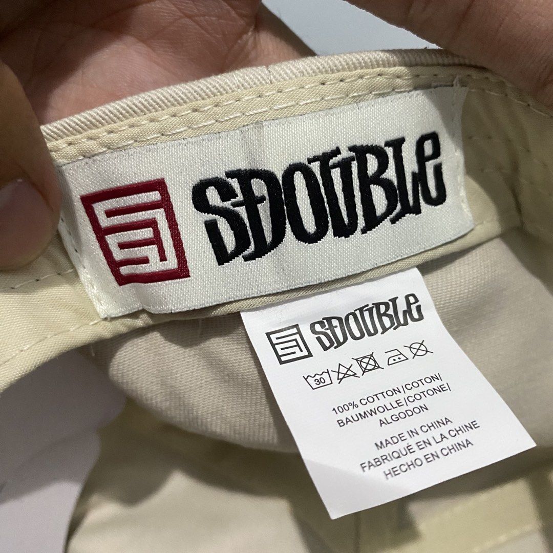 Shaun Stussy Sdouble Snapback Cap (Category: Caps & Hats) located in Imus. Submitted by fndsvntg_307 (Listing ID 1449891193, Image 3). Description: - Sdouble snapback cap - Beige crown with black brim - Sdouble logo embroidered on front - Sdouble signature embroidered on side - Adjustable snap closure at the back - Made of 100% cotton.