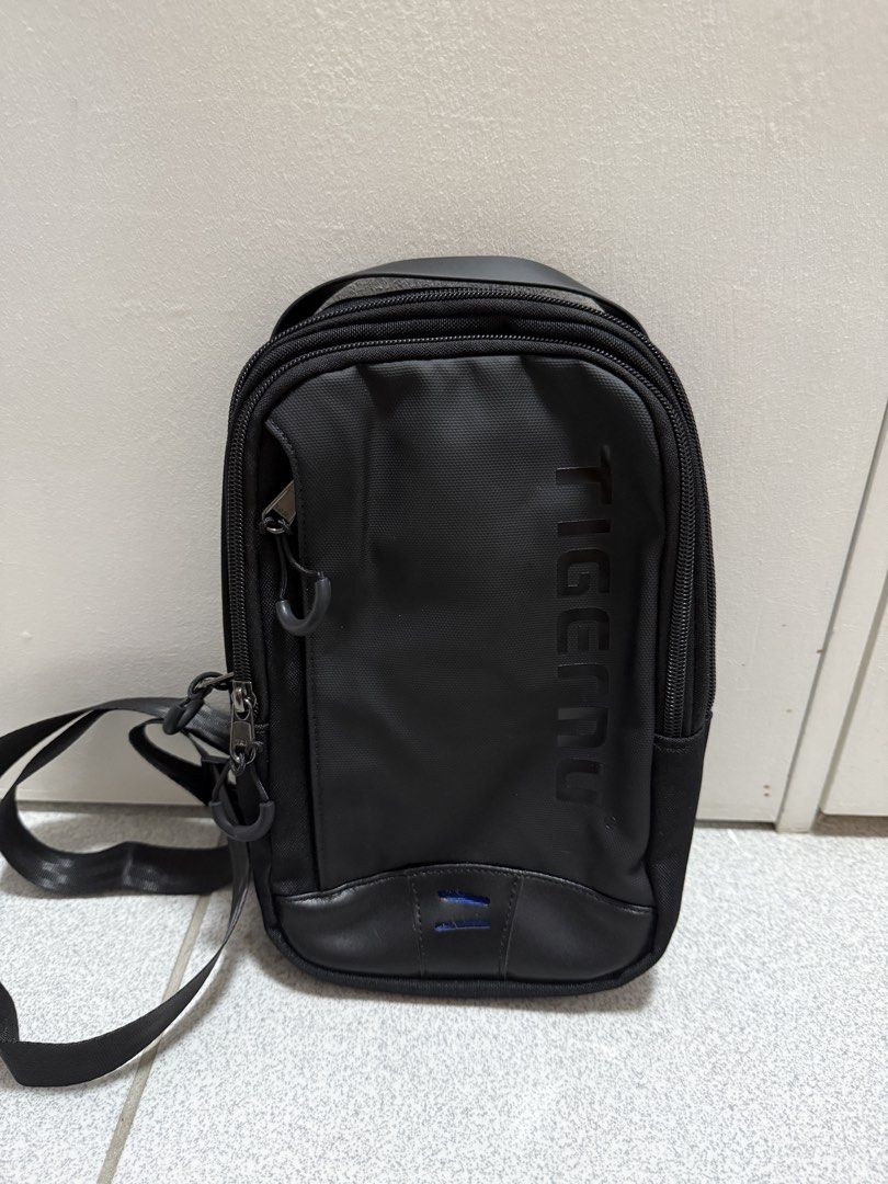 TIGERU Black Sling Bag (Category: Sling Bags) located in San Jose del Monte. Submitted by hellocutease (Listing ID 1449773535, Image 1). Description: - Durable black TIGERU sling bag - Multiple compartments and zippers for organization - Adjustable strap for a comfortable fit - Ideal for everyday use.
