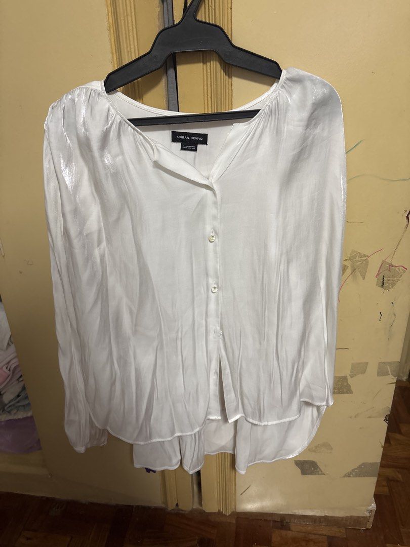 URBAN REVIVO White Button-Up Blouse (Category: Blouses) located in Manila. Submitted by jedispringtime (Listing ID 1449857411, Image 1). Description: - Brand: Urban Revivo - Color: White - Style: Long-sleeved blouse - Fit: Relaxed - Features: Button-up front, subtle sheen - Occasion: Perfect for work or casual outings Missing 2 buttons.