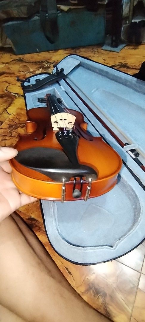 Violin with Case and Bow (Category: Musical Instruments) located in Caloocan City. Submitted by rowely_jpn (Listing ID 1449887772, Image 2). Description: Japan surplus 1/2 size violin. Comes with a case and a bow. The violin has a nice wood grain finish. The case is light blue inside. Great for beginners or intermediate players. Ready to play. Get it now!.