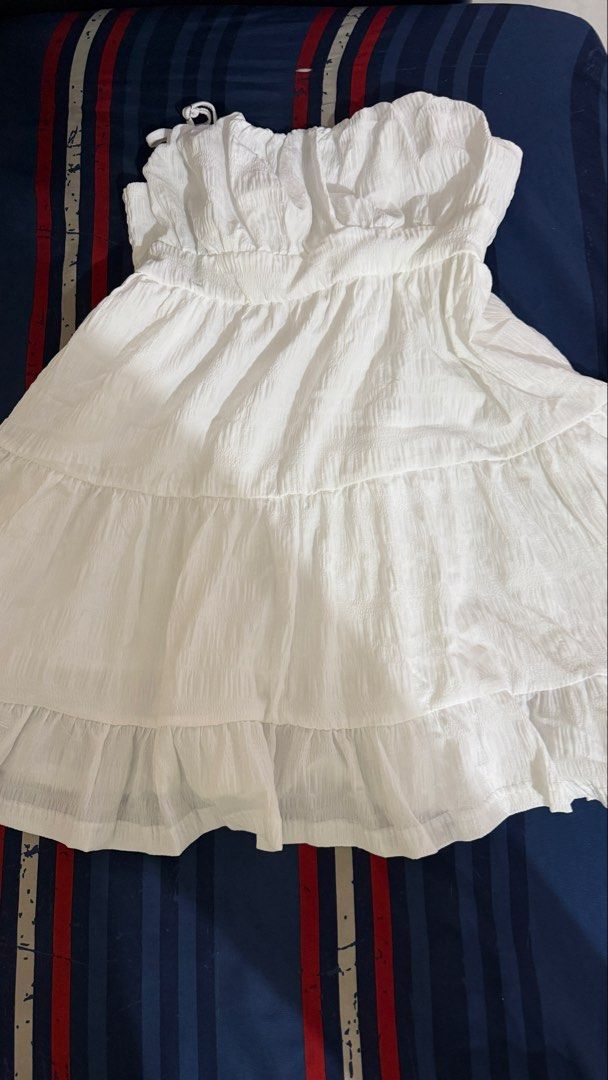 White Tiered Strapless Smocked Dress (Category: Dresses) located in Taguig. Submitted by ericka1213 (Listing ID 1449765203, Image 1). Description: - Cute white strapless dress - Smocked top for a comfortable fit - Tiered ruffles on the skirt - Crinkled fabric texture - Ties at the top - Ideal for summer days or beach vacations - Easy to wear and comfortable.