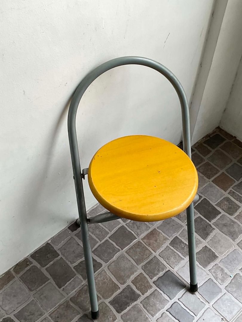 Wooden Round Seat Folding Stool (Category: Chairs) located in Quezon City. Submitted by thriftjunks (Listing ID 1449760386, Image 3). Description: - Compact folding stool - Bright yellow seat - Sturdy grey metal frame - Easy to fold and store - Ideal for extra seating - Suitable for indoor and outdoor use.