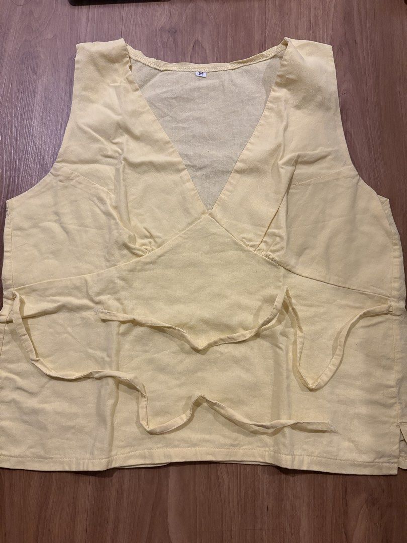 Yellow V-Neck Wrap Style Sleeveless Top Size M (Category: Sleeveless) located in Manila. Submitted by maddsd_ (Listing ID 1449846242, Image 1). Description: - Yellow sleeveless top - V-neckline - Wrap-style front with side tie details - Lightweight fabric - Tagged size M - Ideal for casual wear.