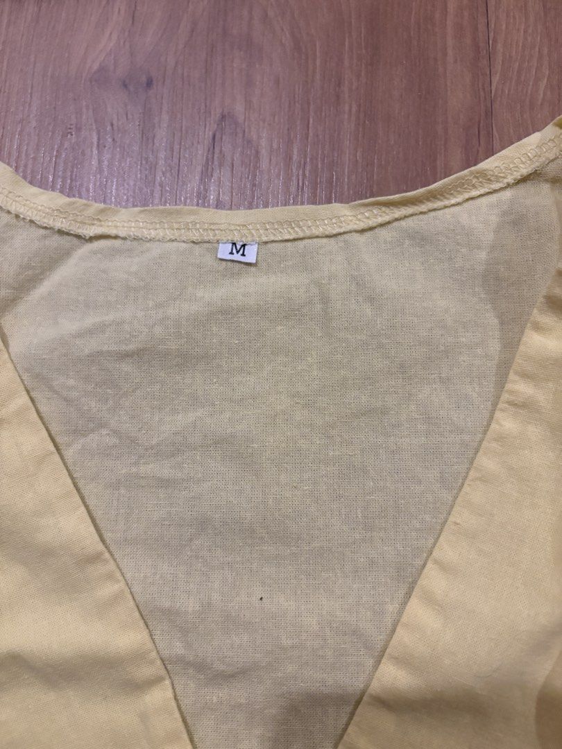 Yellow V-Neck Wrap Style Sleeveless Top Size M (Category: Sleeveless) located in Manila. Submitted by maddsd_ (Listing ID 1449846242, Image 2). Description: - Yellow sleeveless top - V-neckline - Wrap-style front with side tie details - Lightweight fabric - Tagged size M - Ideal for casual wear.