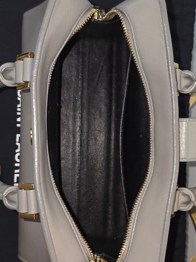 YSL Cabas two way bag (Category: Luxury Bags & Wallets) located in Cebu City. Submitted by anythingunderthesun0211 (Listing ID 1449882901, Image 3). Description: - Grey leather top handle bag by Saint Laurent - Elegant gold hardware details - Comes with a detachable shoulder strap - Includes original dust bag - Black interior lining - Versatile for daily wear or special events.