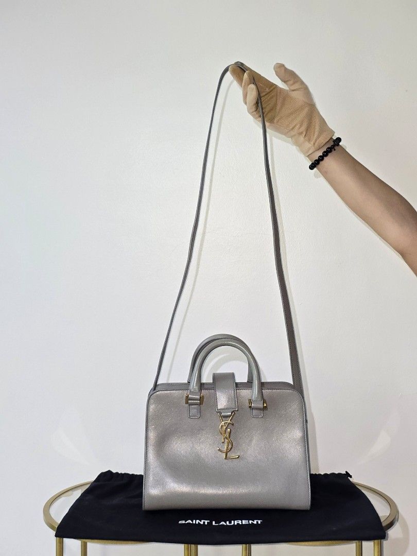 YSL Cabas two way bag (Category: Luxury Bags & Wallets) located in Cebu City. Submitted by anythingunderthesun0211 (Listing ID 1449882901, Image 2). Description: - Grey leather top handle bag by Saint Laurent - Elegant gold hardware details - Comes with a detachable shoulder strap - Includes original dust bag - Black interior lining - Versatile for daily wear or special events.
