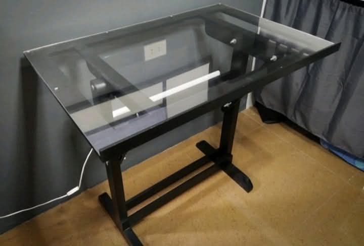 24”x36” Drawing Table (Category: Tables & Sets) located in Lapu Lapu. Submitted by myprelovedpile (Listing ID 1450076927, Image 2). Description: - Material: Wood and acrylic glass - Bought around 2020 for ₱4,000. - Still sturdy and adjustable. - Has some tape marks from use. - Noticed a slight alignment issue when drawing straight 180° lines — could be from the T-square or table edge (not sure). - Great for art, sketching, or general drafting. .
