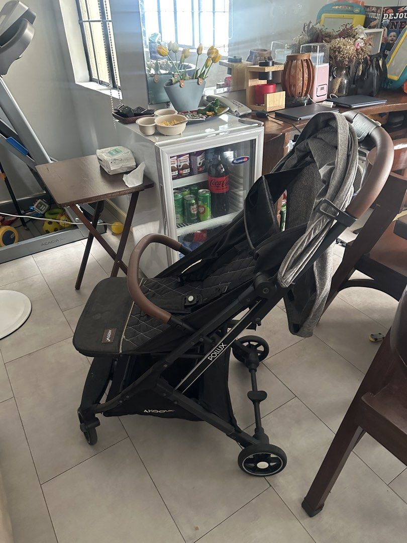 Aprica Rollux Stroller (Category: Strollers) located in Manila. Submitted by pure.brown.sugar (Listing ID 1450120405, Image 2). Description: - Aprica stroller in dark grey with brown handle - Secure 5-point harness - Folds compactly for easy storage - Ideal for everyday use.