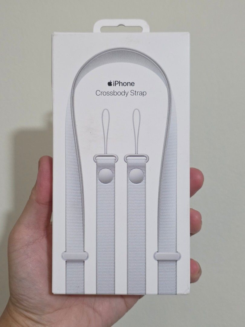 Authentic Apple Crossbody Strap - Light Grey (Category: Mounts & Holders) located in Pasig City. Submitted by gentlephoenix.fe9325 (Listing ID 1449957499, Image 2). Description: (Strap only, case not includes) The Crossbody Strap is designed to attach to selected Apple cases for a convenient and hands‑free way to wear iPhone. Beautifully crafted from 100 per cent recycled PET yarns, the smooth, narrow woven straps drape comfortably across the bod