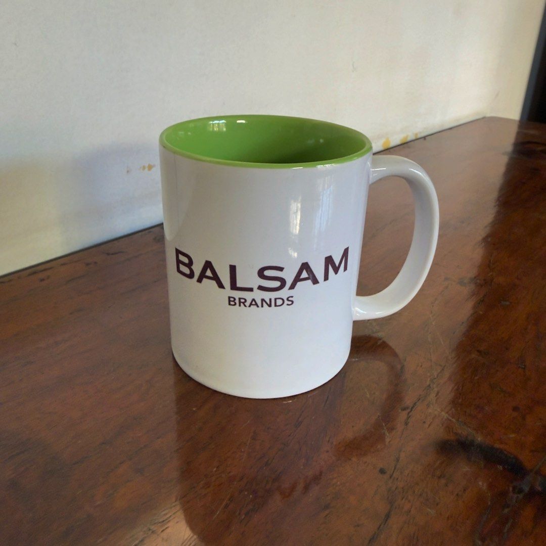 Balsam Brands White Mug with Green Interior (Category: Coffee & Tea Tableware) located in Las Pinas. Submitted by saebisells (Listing ID 1450057767, Image 1). Description: ↠ Classic white mug with a vibrant green interior. ↠ Features the official Balsam Brands logo. ↠ Ideal for your favorite hot beverages like coffee or tea. ↠ Versatile for use at home or in the office. ↠ Simple, timeless design..