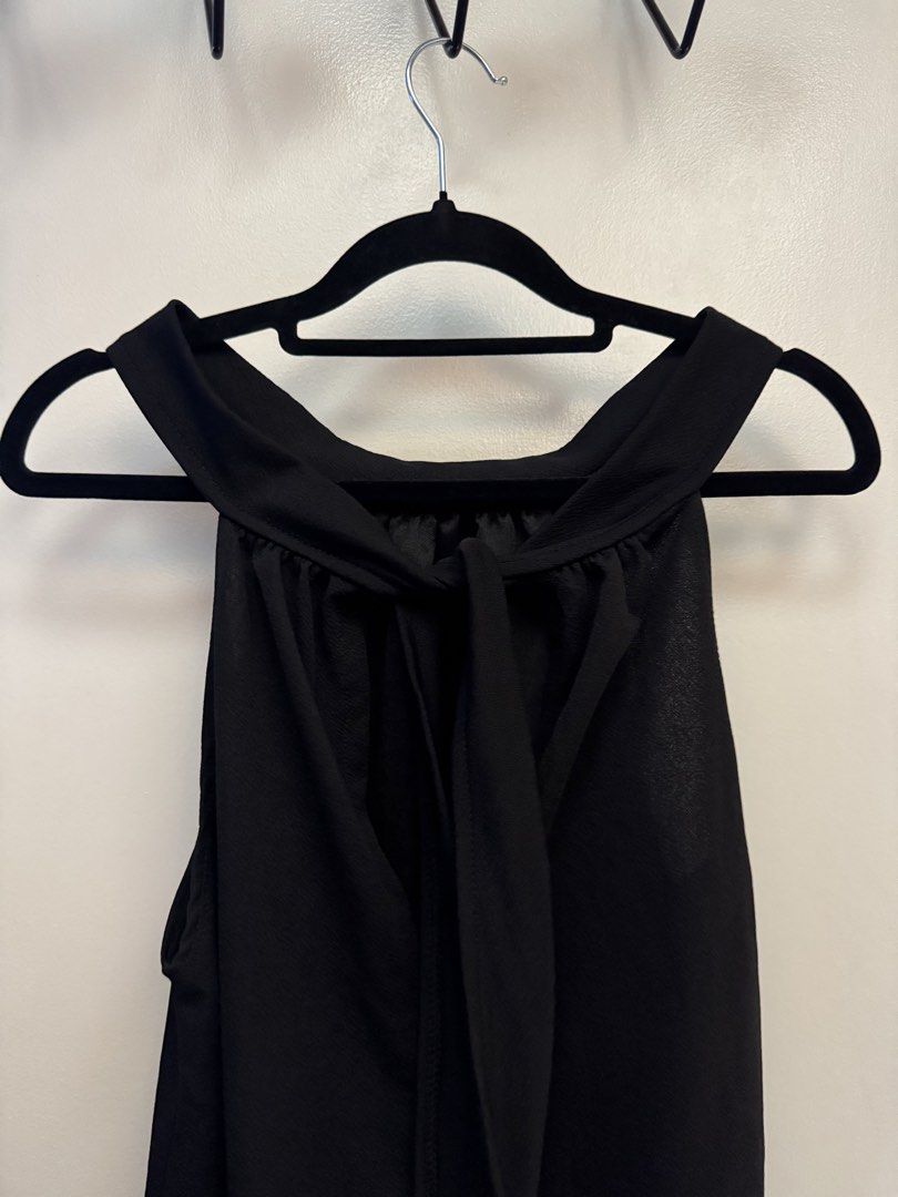 Black Halter Neck Ruffle Hem Dress (Category: Dresses) located in Makati City. Submitted by reenita (Listing ID 1450082628, Image 2). Description: - Sleeveless black dress - Halter neckline with back ties - Tiered ruffle hem - Flowy and comfortable fit - Ideal for night outs or special occasions.