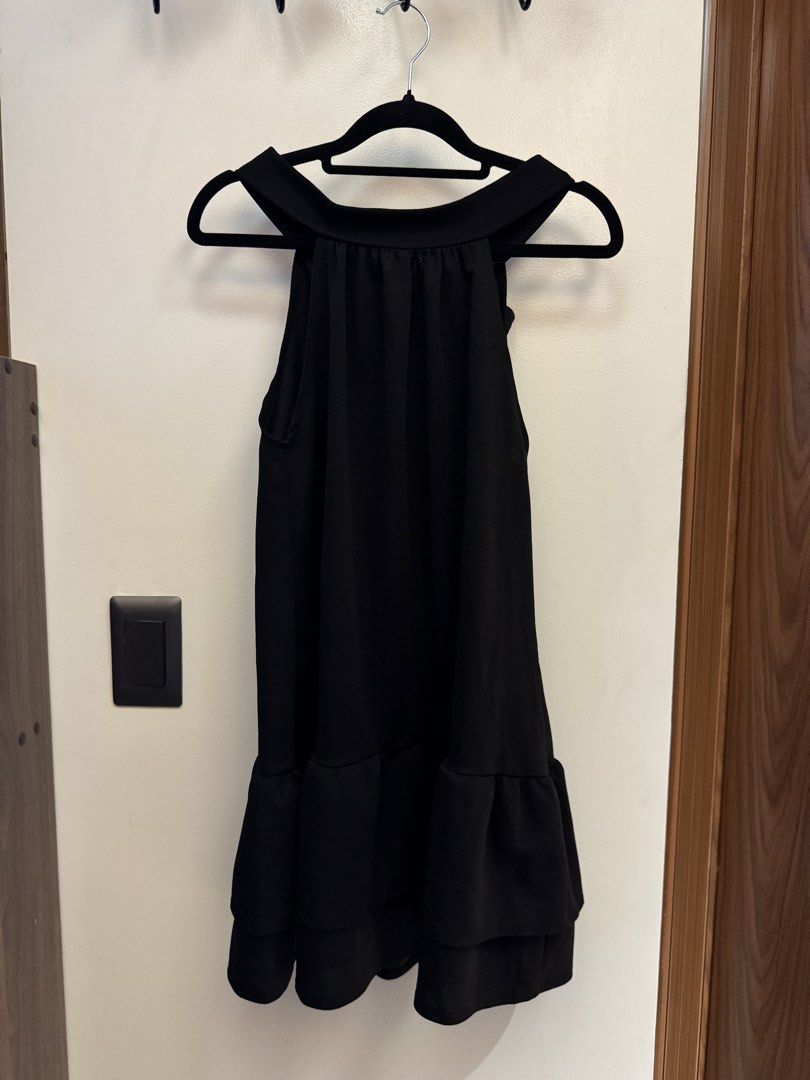 Black Halter Neck Ruffle Hem Dress (Category: Dresses) located in Makati City. Submitted by reenita (Listing ID 1450082628, Image 1). Description: - Sleeveless black dress - Halter neckline with back ties - Tiered ruffle hem - Flowy and comfortable fit - Ideal for night outs or special occasions.