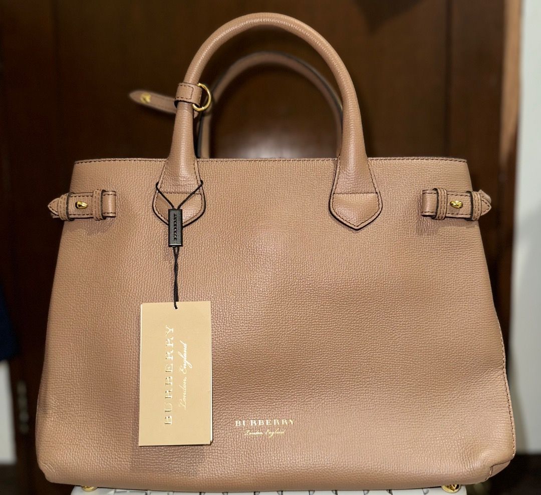Burberry Medium Banner Leather Tote Bag (Category: Luxury Bags & Wallets) located in Santa Rosa. Submitted by ardpilr (Listing ID 1449986735, Image 1). Description: - Classic Burberry Medium Banner tote bag - Tan textured leather - Top handles and crossbody straps - Comes with original dust bag - Comes with original tags still attached - Recently professionally cleaned by Doctor Leather.