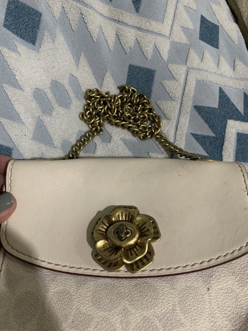 Coach Floral Turnlock Shoulder Bag Cream Monogram (Category: Luxury Bags & Wallets) located in Liloan. Submitted by jinalyns (Listing ID 1450044975, Image 3). Description: Coach shoulder bag in cream with signature monogram print. Features a gold-tone floral turnlock closure. The chain strap is also gold-tone. Comes with a Coach leather hangtag. Interior has a burgundy lining. Great for casual outings..