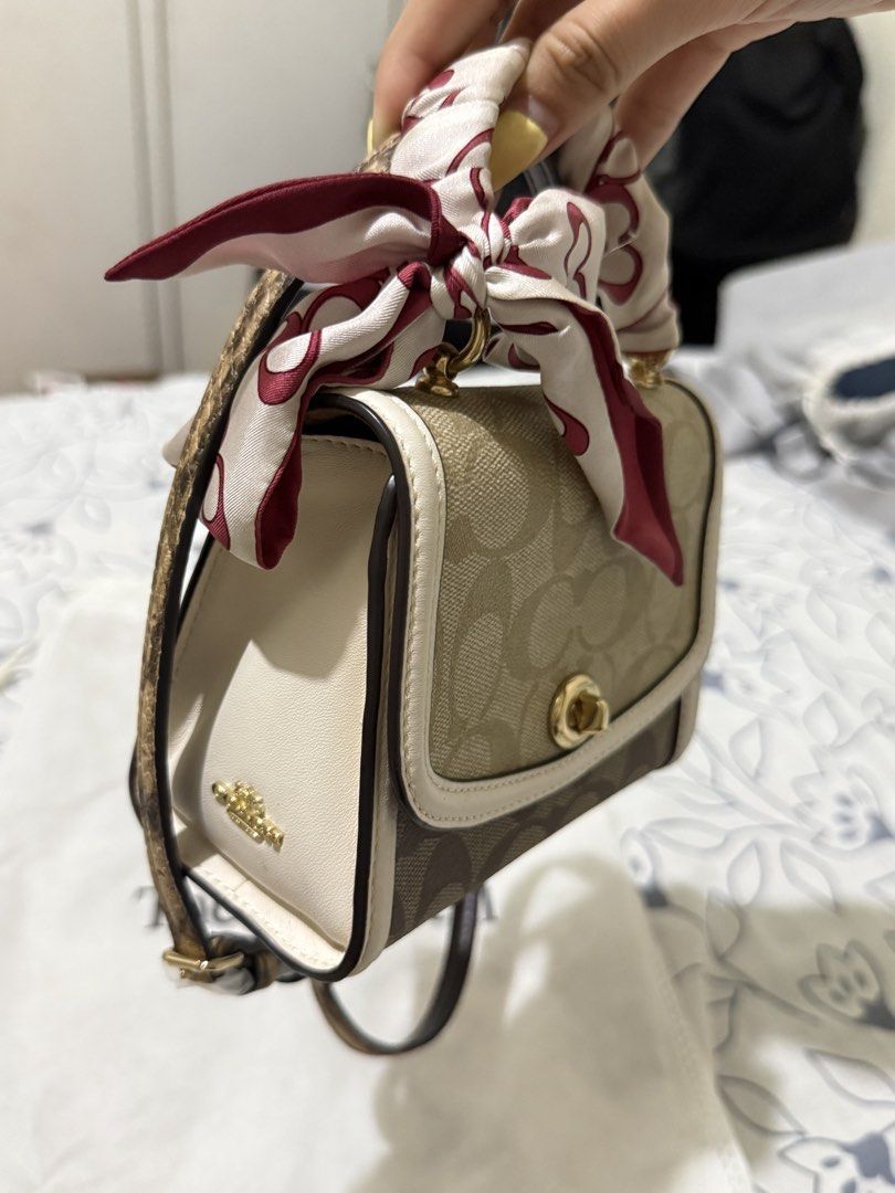 Coach Signature Canvas Micro Mini Bag with Scarf (Category: Luxury Bags & Wallets) located in Angono. Submitted by xxxallaboutbagsxxx (Listing ID 1450003431, Image 3). Description: - Authentic Coach Signature Canvas Micro Mini Bag - Comes with a cute scarf tied to the handle - Includes a crossbody strap - Interior has a small pocket - Original tags still attached - Purchased from The Real Real.