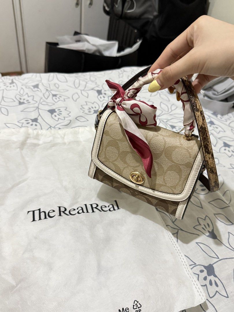 Coach Signature Canvas Micro Mini Bag with Scarf (Category: Luxury Bags & Wallets) located in Angono. Submitted by xxxallaboutbagsxxx (Listing ID 1450003431, Image 1). Description: - Authentic Coach Signature Canvas Micro Mini Bag - Comes with a cute scarf tied to the handle - Includes a crossbody strap - Interior has a small pocket - Original tags still attached - Purchased from The Real Real.