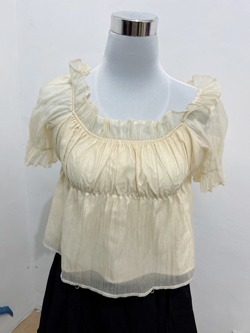 Cream Organza Off-Shoulder Top (Category: Blouses) located in Subic. Submitted by pamyucosrental (Listing ID 1450084094, Image 2). Description: 🧚‍♀️ [RUSH DECLUTTER] Cream Shimmer Organza Off-Shoulder Top 💵 PRICE: ₱99 ONLY! 👗 SIZE: Free Size (Stretchable neckline and chest area, fits Small to Medium) ✨ DESCRIPTION: • Beautiful cream/champagne shimmer fabric that catches the light • Flowy ruffle sleeves, can be worn off-shoulder or square neck 