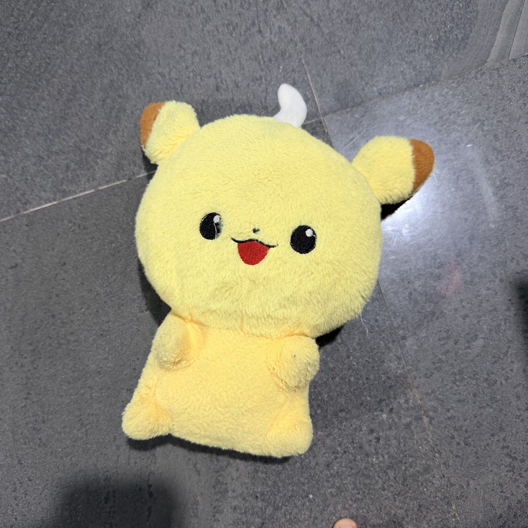 Cute Yellow Pikachu-like Plush Toy (Category: Plushies & Soft Toys) located in Quezon City. Submitted by ThirftyClub (Listing ID 1449953371, Image 1). Description: - Super soft and cuddly yellow plush toy - Features big black eyes and a little red tongue sticking out - Brown-tipped ears add a cute detail - Perfect size (palm-sized) for hugging or display - Ideal gift for Pokemon fans, kids, or adults who love plushies.