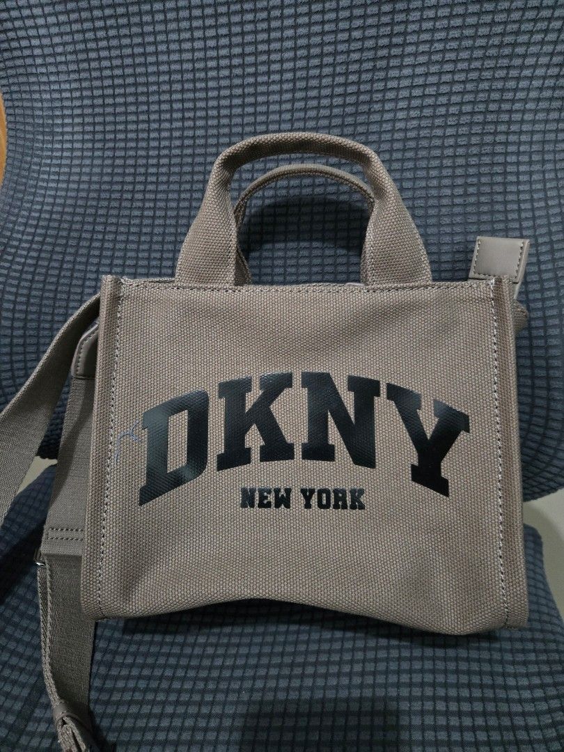 DKNY New York Canvas Tote Bag (Category: Tote Bags) located in Manila. Submitted by opssyyyy (Listing ID 1450035726, Image 1). Description: - Brand: DKNY New York - Type: Canvas Tote Bag - Color: Tan with black lettering - Features: Top handles, detachable shoulder strap, zipper closure - Origin: Made in Cambodia - Ideal for: Everyday use, travel.