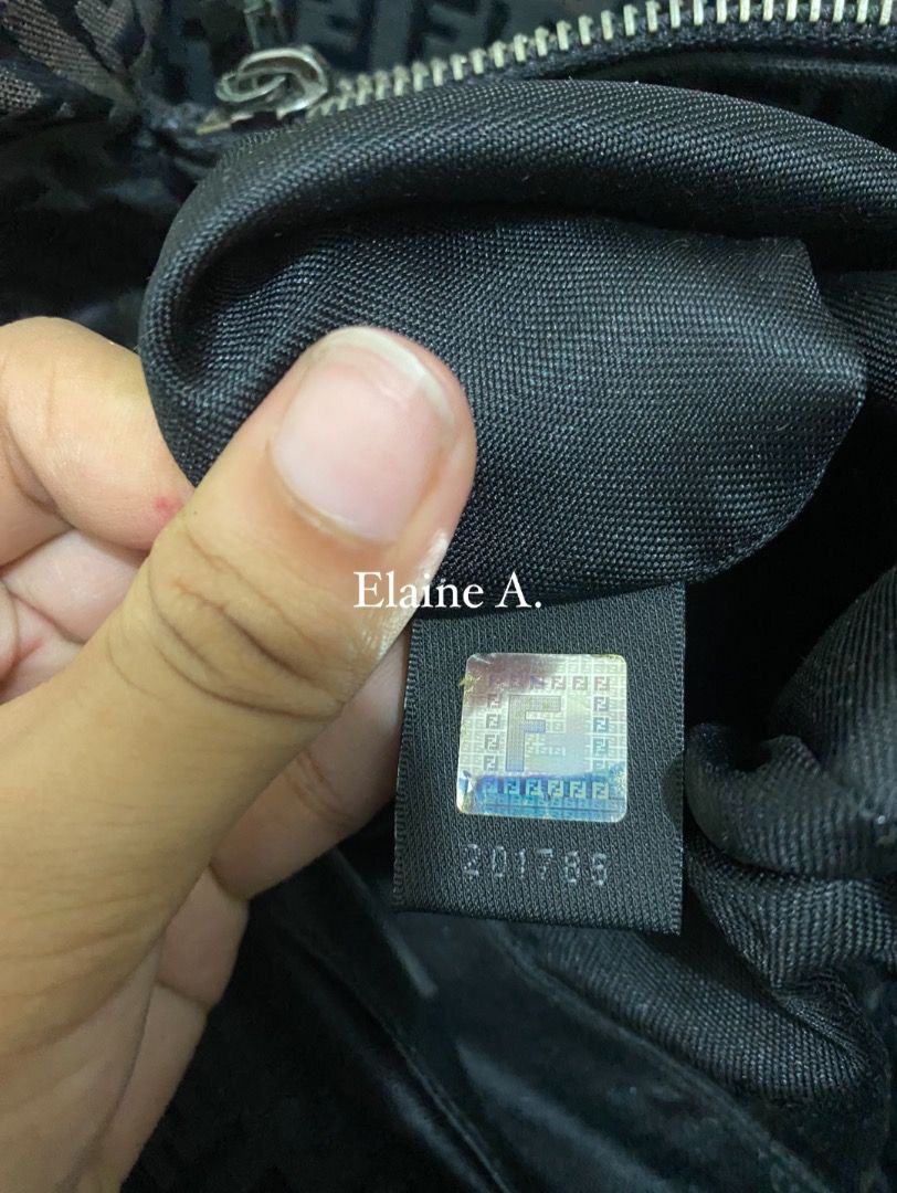 Fendi Zucca Pattern Tote Bag (Category: Luxury Bags & Wallets) located in Paete. Submitted by ladder_leynn (Listing ID 1450123518, Image 3). Description: - Authentic Fendi tote bag - Classic Zucca monogram pattern - Black fabric with dark brown leather handles - Zipper closure - Interior zipped pocket - Serial number visible in photos - Perfect everyday bag.