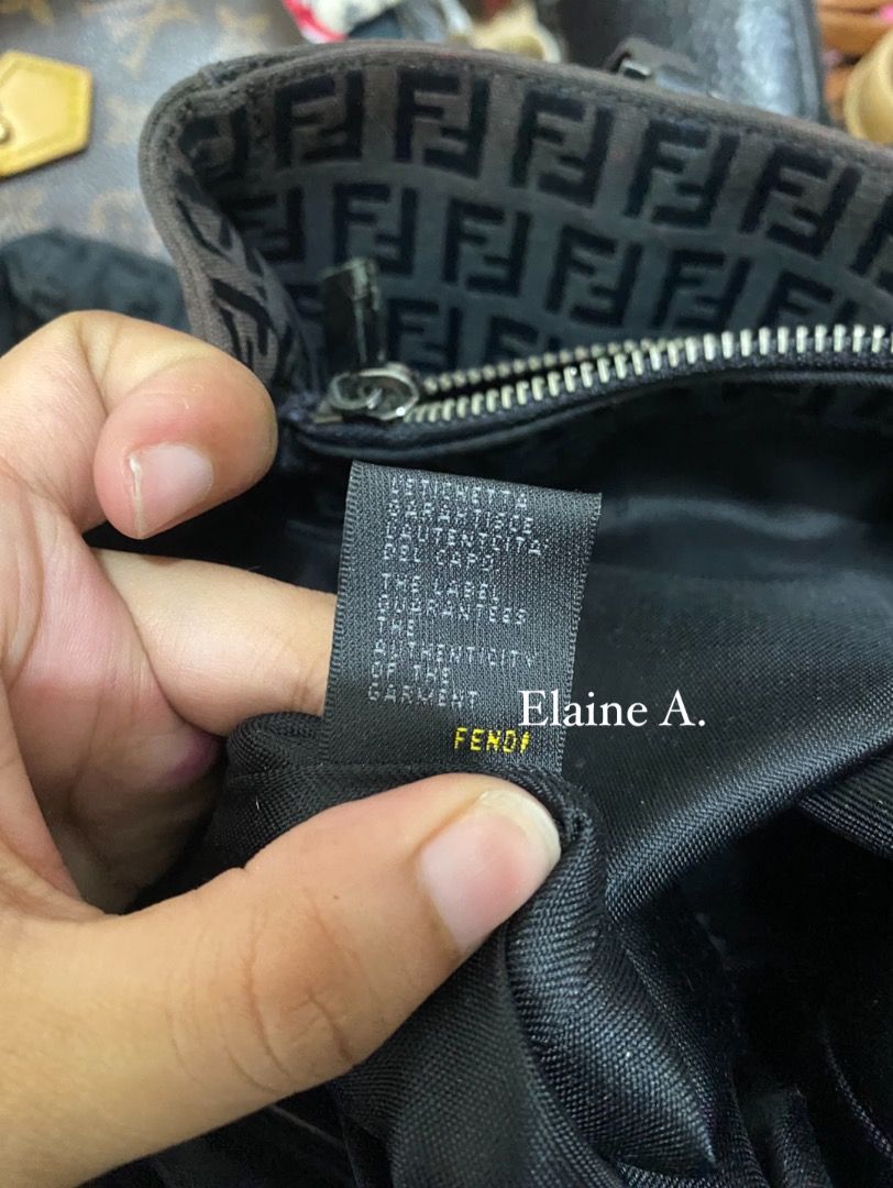 Fendi Zucca Pattern Tote Bag (Category: Luxury Bags & Wallets) located in Paete. Submitted by ladder_leynn (Listing ID 1450123518, Image 2). Description: - Authentic Fendi tote bag - Classic Zucca monogram pattern - Black fabric with dark brown leather handles - Zipper closure - Interior zipped pocket - Serial number visible in photos - Perfect everyday bag.