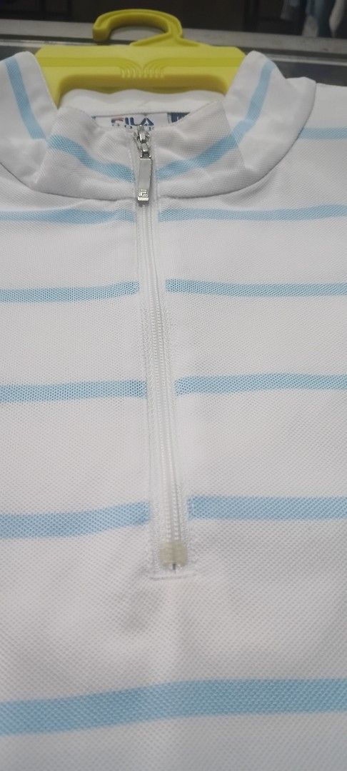 Fila Golf Striped Polo Shirt LL (Category: Tshirts & Polo Shirts) located in Senawang. Submitted by kedailanbundle (Listing ID 1450043979, Image 2). Description: - Fila Golf polo shirt - Color: White with light blue stripes - Neckline: Quarter zip - Size: LL (Large Large) - Features: Crest detail on chest - Ideal for: Golfing or casual wear pit 21 labuh 28 harga termasuk pos semenanjung sahaja.