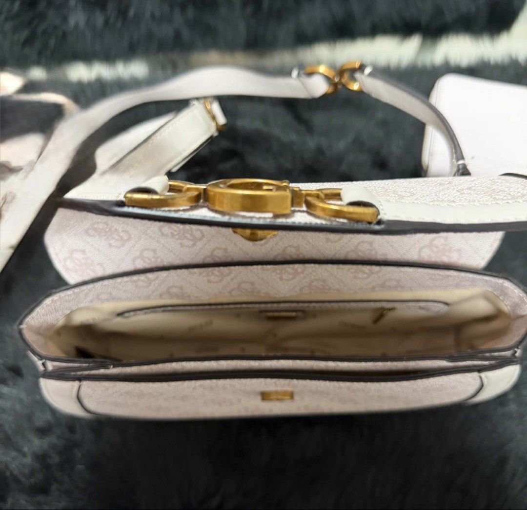 Guess Monogram Shoulder Bag White (Category: Luxury Bags & Wallets) located in Bacoor. Submitted by cielo1985 (Listing ID 1450061493, Image 2). Description: - White Guess shoulder bag - Signature monogram pattern - Gold hardware details - Adjustable strap - Flap closure - Main interior compartment - Great for everyday use - Clean inside and out.