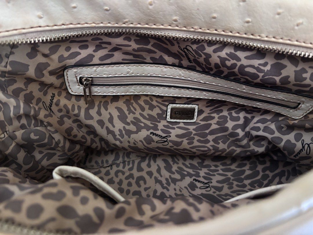 Guess Ostrich Embossed Satchel Handbag (Category: Luxury Bags & Wallets) located in Santa. Submitted by dmb.sam (Listing ID 1450025202, Image 2). Description: - Guess satchel bag - Cream and brown color - Ostrich embossed texture all over - Front flap pocket with Guess logo detail - Zipper closure - Interior zippered pocket - Leopard print lining - Taupe colored handles - Ideal for everyday use.