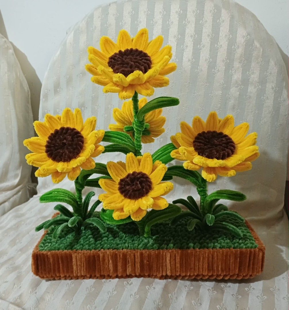Handmade Sunflower Arrangement in Pot (Category: Artificial Plants & Flowers) located in Manila. Submitted by amitz (Listing ID 1450003698, Image 1). Description: - Adorable handmade sunflower arrangement - Features 5 bright sunflowers with brown centers and yellow petals - Realistic green stems and leaves - Comes in a textured brown pot - Topped with green grass-like material - Ideal for home decor or as a thoughtful gift - Brings a cheerful vib