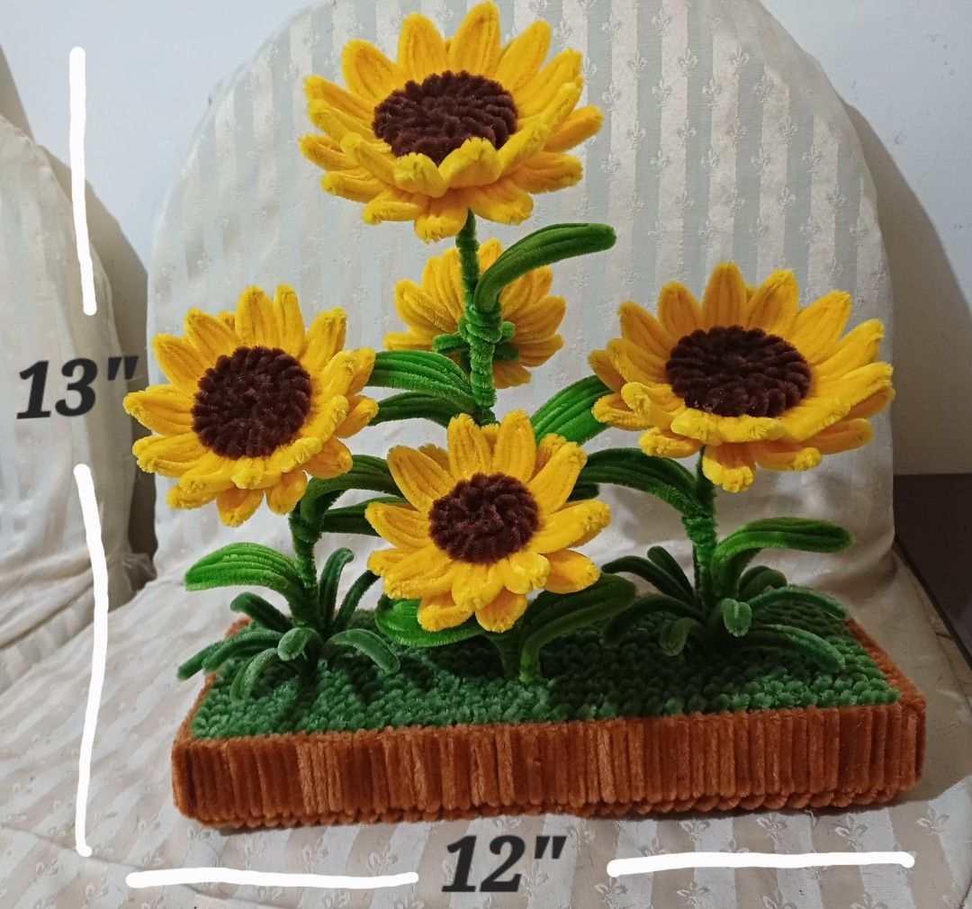 Handmade Sunflower Arrangement in Pot (Category: Artificial Plants & Flowers) located in Manila. Submitted by amitz (Listing ID 1450003698, Image 2). Description: - Adorable handmade sunflower arrangement - Features 5 bright sunflowers with brown centers and yellow petals - Realistic green stems and leaves - Comes in a textured brown pot - Topped with green grass-like material - Ideal for home decor or as a thoughtful gift - Brings a cheerful vib