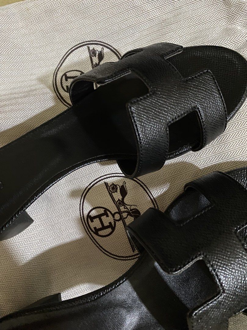 Hermes Oran Black Leather Heels (Category: Flats & Sandals) located in Manila. Submitted by summerstyled (Listing ID 1450132663, Image 2). Description: -Comes with dustbag - Classic black leather Hermes H sandals - Stylish and comfortable for any occasion - Features textured leather for added detail - Easy slip-on design - A timeless addition to your wardrobe.