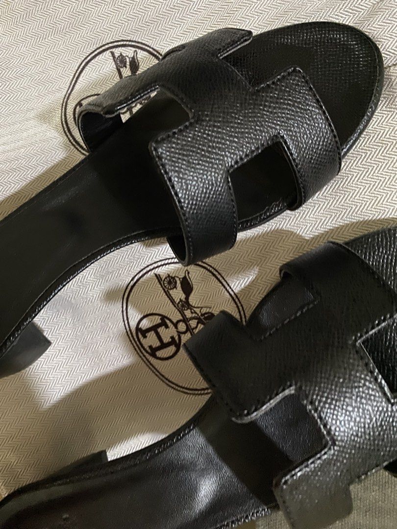 Hermes Oran Black Leather Heels (Category: Flats & Sandals) located in Manila. Submitted by summerstyled (Listing ID 1450132663, Image 3). Description: -Comes with dustbag - Classic black leather Hermes H sandals - Stylish and comfortable for any occasion - Features textured leather for added detail - Easy slip-on design - A timeless addition to your wardrobe.