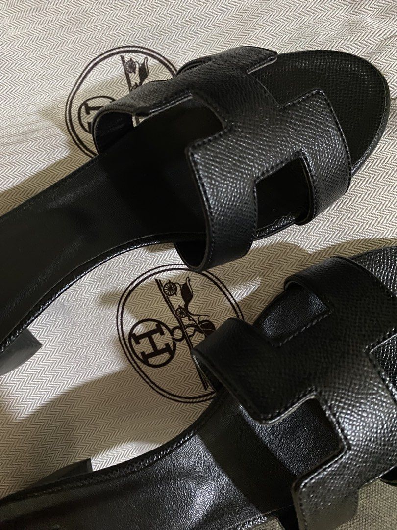 Hermes Oran Black Leather Heels (Category: Flats & Sandals) located in Manila. Submitted by summerstyled (Listing ID 1450132663, Image 1). Description: -Comes with dustbag - Classic black leather Hermes H sandals - Stylish and comfortable for any occasion - Features textured leather for added detail - Easy slip-on design - A timeless addition to your wardrobe.