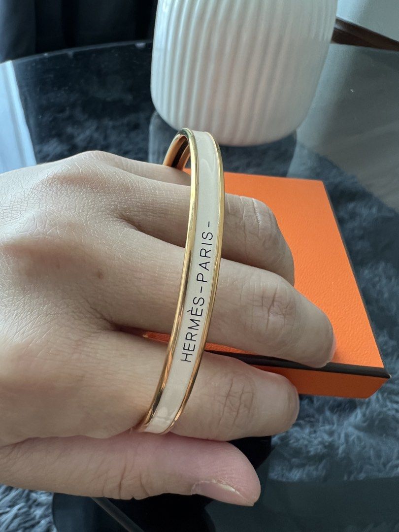 Hermes Uni Bangle (Category: Bracelets) located in Kuala Lumpur. Submitted by emma_alicia28 (Listing ID 1449967307, Image 3). Description: - Authentic Hermes Paris bangle - Classic white enamel with gold trim - Comes with original Hermes box.