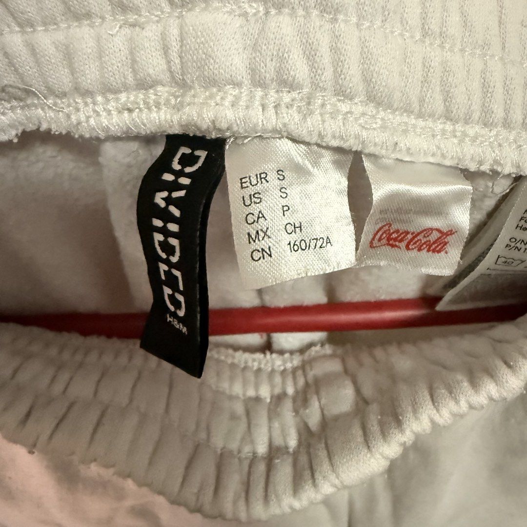 H&M Divided x Coca-Cola White Sweatpants Size S (Category: Other Bottoms) located in Batangas. Submitted by baners.26 (Listing ID 1450131308, Image 2). Description: - White sweatpants with cool Coca-Cola graphics - Elastic waistband and cuffs for a comfy fit - H&M Divided collaboration - Size S - Ideal for everyday casual wear.