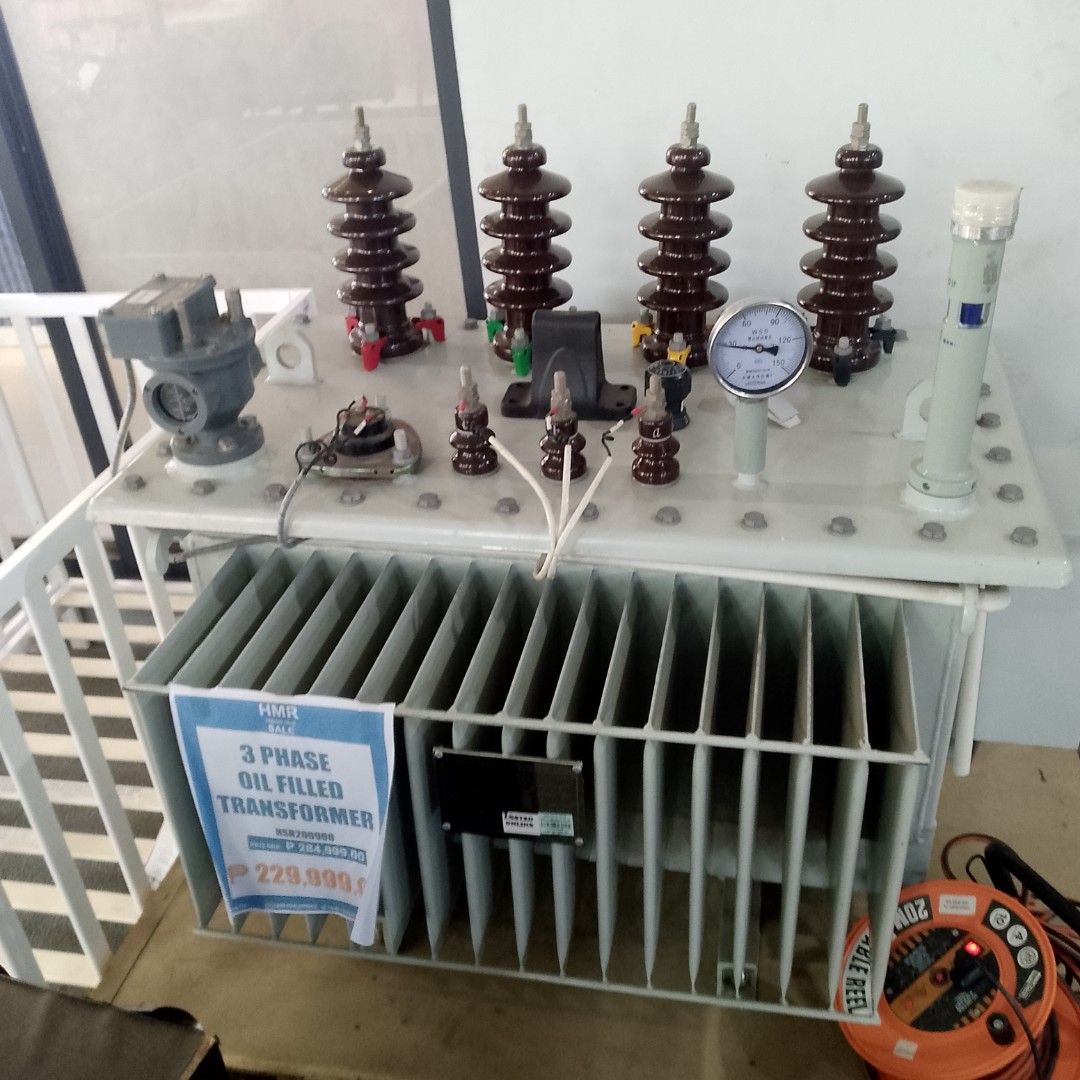 HMR 3 Phase Oil Filled Transformer (Category: Electrical, Adaptors & Sockets) located in Manila. Submitted by cleverwolf.07545a (Listing ID 1449959704, Image 1). Description: - 3-phase oil-filled transformer - Pressure gauge included - Multiple ceramic insulators - Mounted on a white metal frame with cooling fins - Perfect for industrial applications - Price: P229,999.