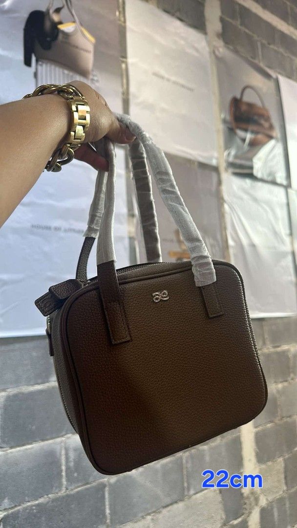 HOLB (Category: Luxury Bags & Wallets) located in Manila. Submitted by clarencelising (Listing ID 1450064850, Image 3). Description: - Stylish brown textured leather handbag - Features both top handles and a detachable crossbody strap - Prominent logo detail on the front - Compact size: 22cm - Ideal for everyday wear and tear - with DUST bag and Eco Bag from HOLB.
