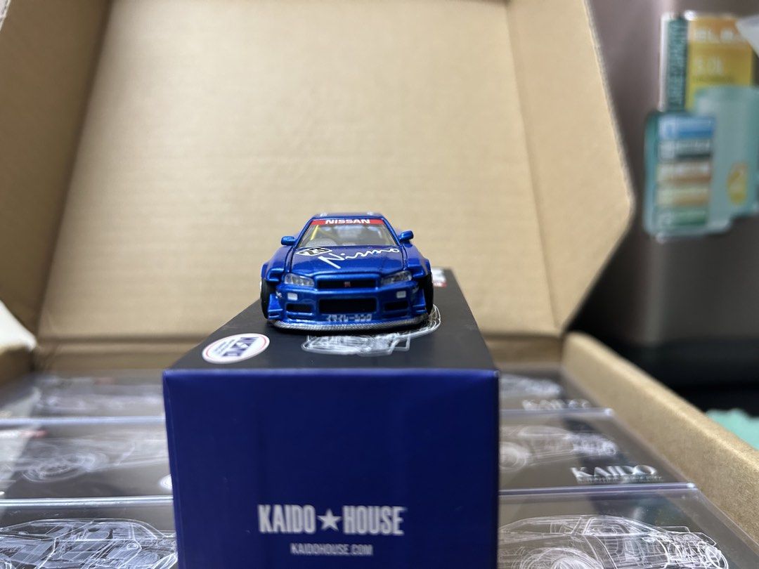 KAIDO HOUSE R34 white & blue (lot) (Category: Toys & Games) located in Kuala Lumpur. Submitted by Dannyz (Listing ID 1450069302, Image 3). Description: - KAIDO HOUSE x MINI GT Nissan Skyline GT-R (R34) NISMO - Model Number: 055 - Striking blue color with authentic NISMO livery - Features an opening hood for detailed viewing - Comes in its original, pristine box - A must-have addition for any diecast car collector UNSEAL .