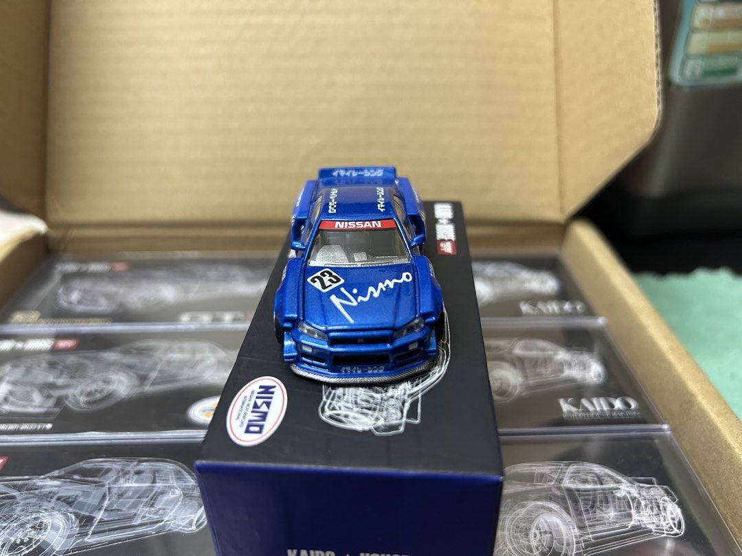 KAIDO HOUSE R34 white & blue (lot) (Category: Toys & Games) located in Kuala Lumpur. Submitted by Dannyz (Listing ID 1450069302, Image 2). Description: - KAIDO HOUSE x MINI GT Nissan Skyline GT-R (R34) NISMO - Model Number: 055 - Striking blue color with authentic NISMO livery - Features an opening hood for detailed viewing - Comes in its original, pristine box - A must-have addition for any diecast car collector UNSEAL .