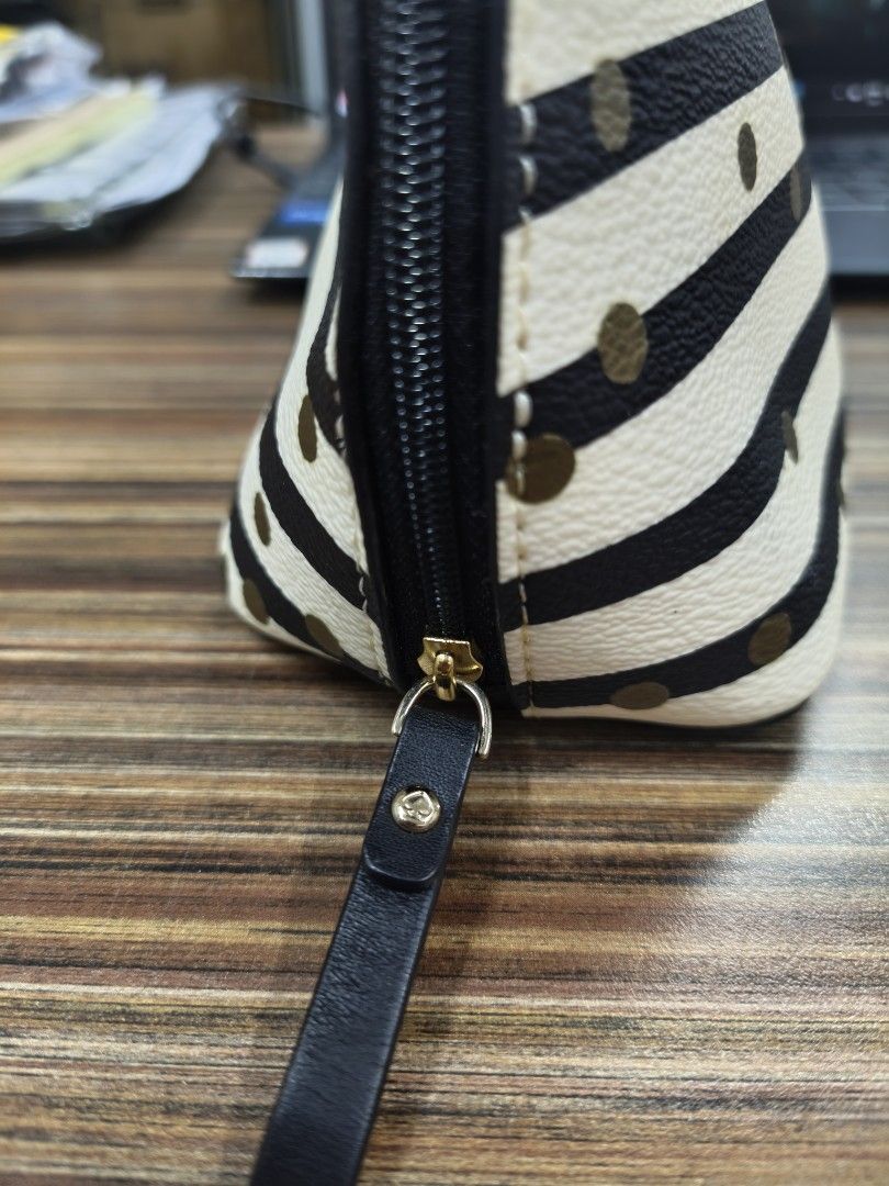 Kate Spade Striped Polka Dot Cosmetic Bag (Category: Luxury Bags & Wallets) located in Antipolo. Submitted by prelovedbyfhaye (Listing ID 1449977948, Image 3). Description: - Authentic Kate Spade cosmetic bag / pouch - Chic black and white stripe design with gold polka dots - Secure zipper closure with a stylish leather pull tab - Ideal for storing makeup, toiletries, or travel essentials - Compact size fits easily into your daily handbag.