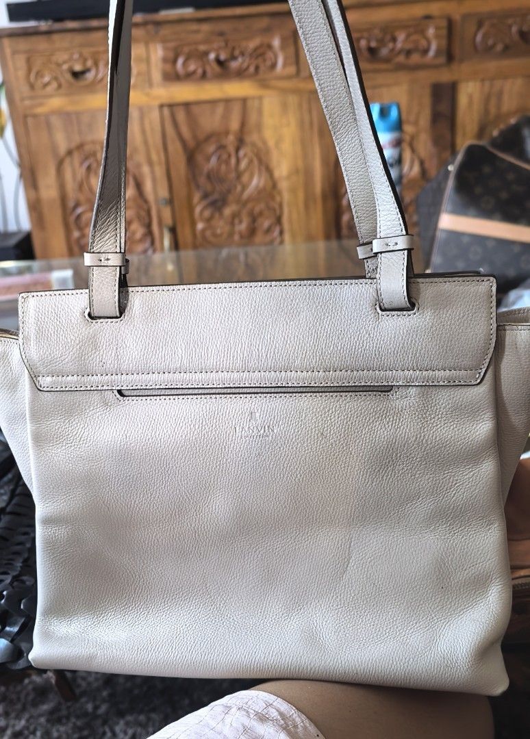 Lanvin Tote Bag (Category: Luxury Bags & Wallets) located in Cagayan de Oro. Submitted by tommygurl1218 (Listing ID 1450023802, Image 2). Description: - Lanvin tote bag - Color: off white /light gray - Material: Leather - Closure: Flap with metal logo detail, interior zipper - Straps: Adjustable - Size: Ideal for everyday use - Condition: Please check photos for details With minimal. Sign of use .
