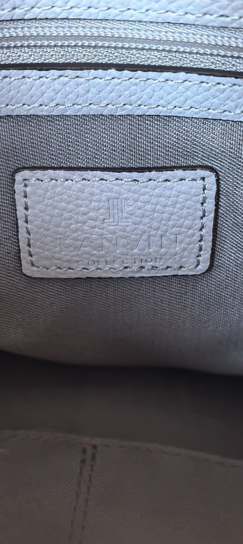 Lanvin Tote Bag (Category: Luxury Bags & Wallets) located in Cagayan de Oro. Submitted by tommygurl1218 (Listing ID 1450023802, Image 3). Description: - Lanvin tote bag - Color: off white /light gray - Material: Leather - Closure: Flap with metal logo detail, interior zipper - Straps: Adjustable - Size: Ideal for everyday use - Condition: Please check photos for details With minimal. Sign of use .