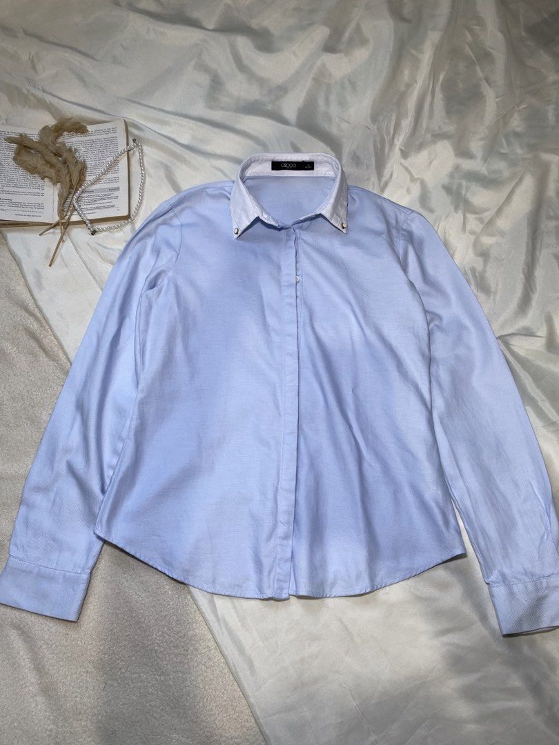 Light Blue Button-Up Shirt with White Collar Small Bust 34 (Category: Tshirts & Polo Shirts ) located in Poro. Submitted by joyceyuu (Listing ID 1450049096, Image 1). Description: - Classic light blue button-up shirt - Crisp white collar with subtle gold accents - Long sleeves with button cuffs - Sharp and clean look - Versatile for work or casual wear - Easy to pair with any outfit.