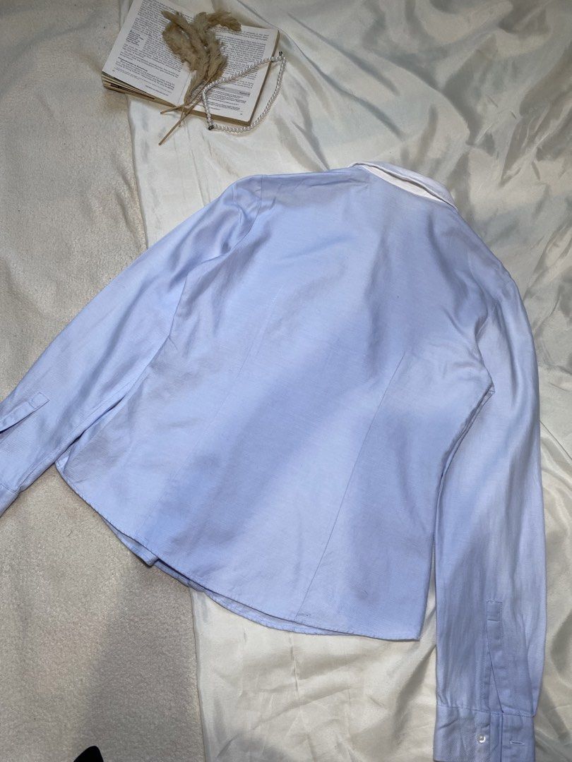 Light Blue Button-Up Shirt with White Collar Small Bust 34 (Category: Tshirts & Polo Shirts ) located in Poro. Submitted by joyceyuu (Listing ID 1450049096, Image 3). Description: - Classic light blue button-up shirt - Crisp white collar with subtle gold accents - Long sleeves with button cuffs - Sharp and clean look - Versatile for work or casual wear - Easy to pair with any outfit.