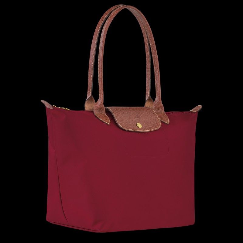 Longchamp Le Pliage Tote Bag Red Large (Category: Luxury Bags & Wallets) located in Gapan. Submitted by mdcollection.ph (Listing ID 1450082631, Image 2). Description: - Classic Longchamp tote bag - Rich burgundy color - Durable nylon with genuine leather handles - Folds flat for convenient storage - Ideal for everyday use, work, or travel - Generous interior space.