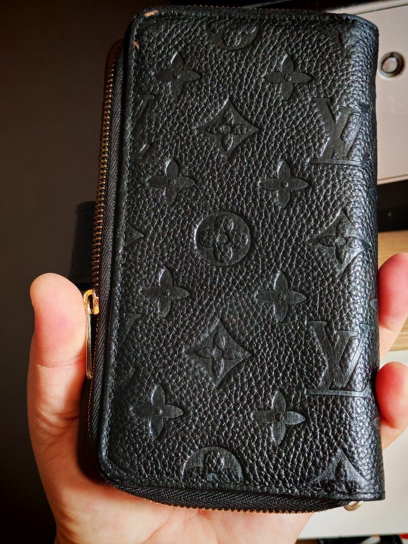 Louis Vuitton Monogram Empreinte Zipped Wallet (Category: Luxury Bags & Wallets) located in Manila. Submitted by cleverwhale_45b7bc (Listing ID 1449962379, Image 2). Description: - Louis Vuitton Wallet - Color: Black - Material: Monogram Empreinte Leather - Closure: Zip-around - Interior: Multiple card slots, zipped compartment - Hardware: Gold-tone - Dimensions (approx.): 7.5 x 4.5 inches (when closed) - Functionality: Ideal for organizing cards