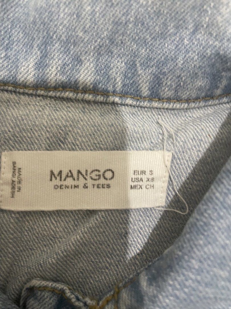 Mango Light Wash Denim Jacket - Size XS (Category: Coats, Jackets and Outerwear) located in Guiguinto. Submitted by beatan13 (Listing ID 1450082499, Image 3). Description: - Classic light wash denim jacket by Mango. - Button-up front closure. - Two functional chest pockets. - Long sleeves with button cuffs. - A versatile wardrobe staple, easy to style with anything. - Made in Bangladesh..