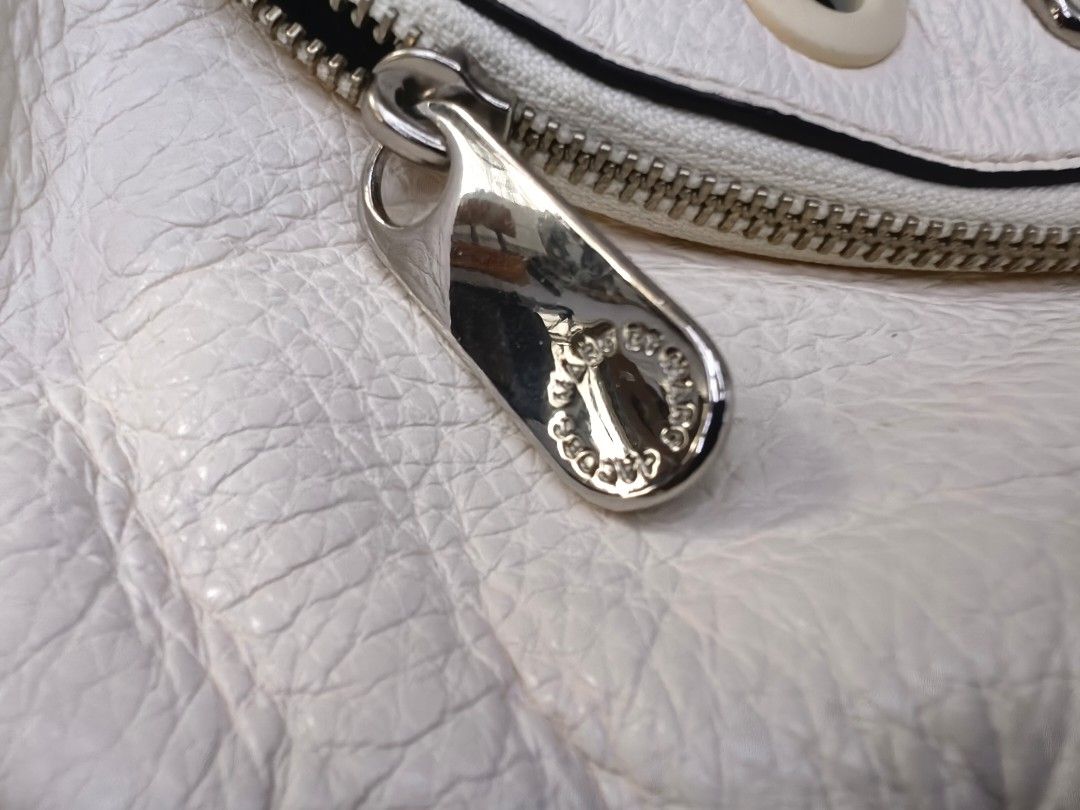Marc by Marc Jacobs White Leather Studded Shoulder Bag (Category: Luxury Bags & Wallets) located in Quezon City. Submitted by flat.earther23 (Listing ID 1450007628, Image 3). Description: - Authentic Marc by Marc Jacobs white leather shoulder bag - Features a cool studded detail on the front flap - Secure zipper closure - Adjustable strap for comfortable wear - Interior zippered pocket for essentials - Ideal for everyday use.