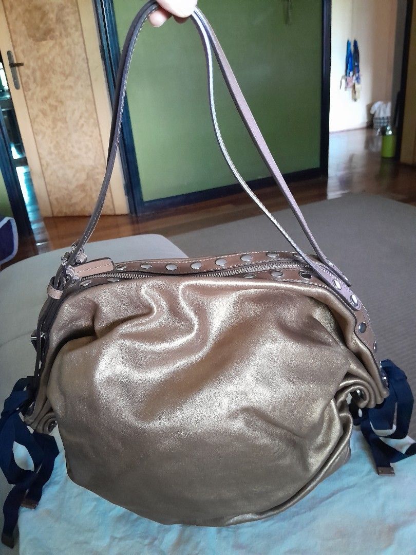 Marni Metallic Leather Studded hobo Bag (Category: Luxury Bags & Wallets) located in Quezon City. Submitted by mmamma.mi.a. (Listing ID 1449999272, Image 2). Description: - authentic Marni hobo bag with flat pouch inside. - made in italy 16"x10 " - very nice Metallic bronze/gold soft leather - Silver stud detailing on zipper and straps - Adjustable leather straps - Interior zip pocket - Comes with dust bag - Versatile for everyday use Used a few 