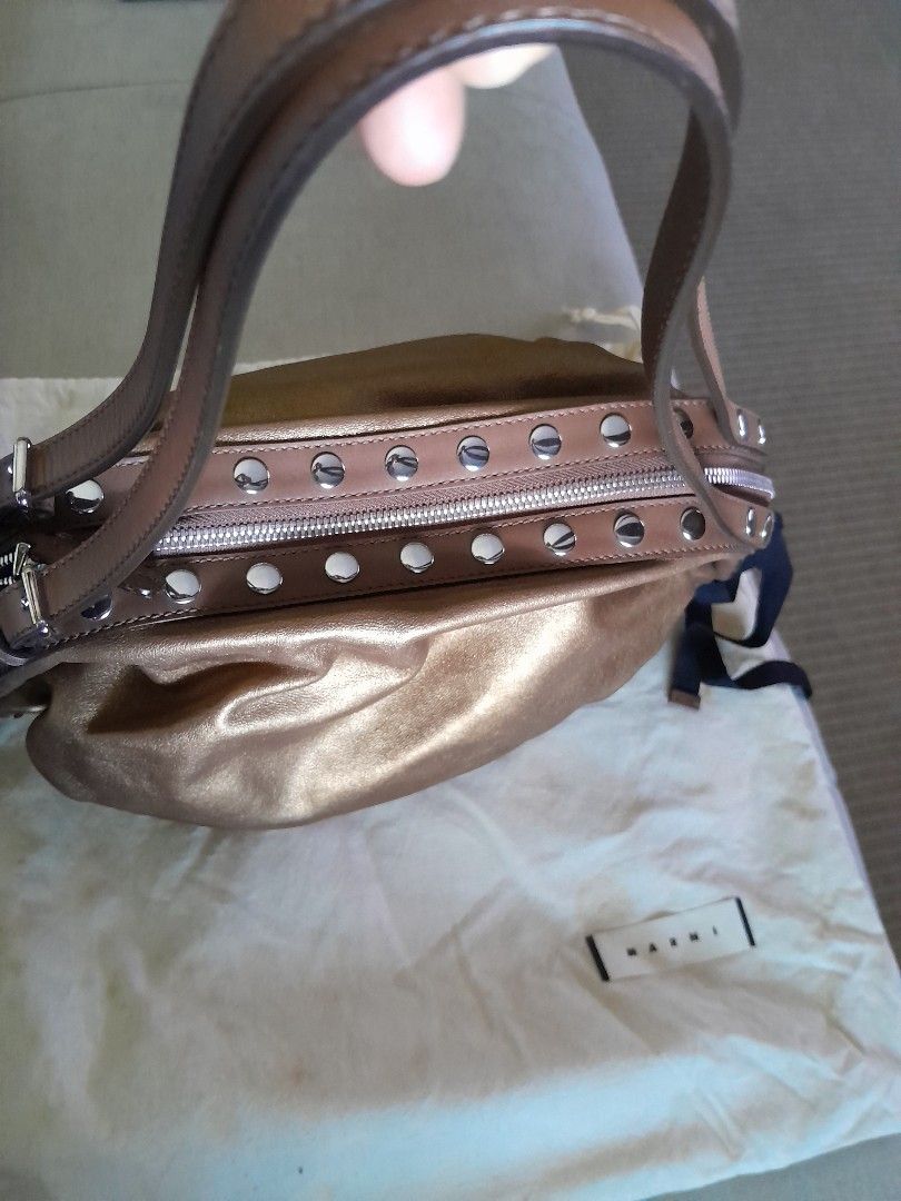 Marni Metallic Leather Studded hobo Bag (Category: Luxury Bags & Wallets) located in Quezon City. Submitted by mmamma.mi.a. (Listing ID 1449999272, Image 3). Description: - authentic Marni hobo bag with flat pouch inside. - made in italy 16"x10 " - very nice Metallic bronze/gold soft leather - Silver stud detailing on zipper and straps - Adjustable leather straps - Interior zip pocket - Comes with dust bag - Versatile for everyday use Used a few 